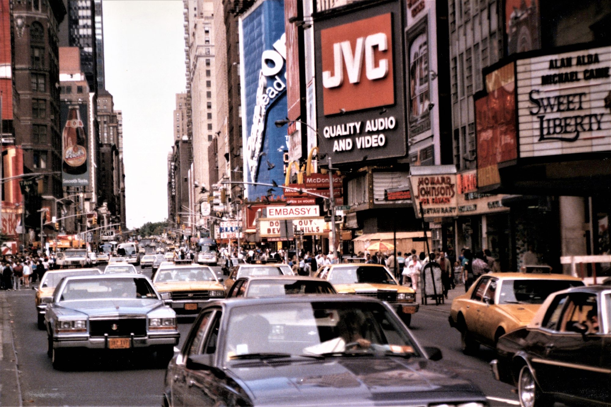 Times Square, New York, 1986 &mdash; a busy Midtown Manhattan street full of taxis beneath a JVC billboard